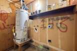 This utility room features a large water heater, perfect for a growing family or busy household.