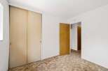 Step into this inviting bedroom, featuring a spacious closet with sliding doors, perfect for ample storage.
