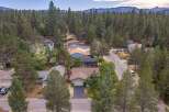 Discover this charming home nestled amongst towering pine trees, offering a serene and private retreat.