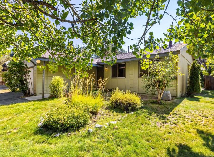 Charming single-story home with a welcoming covered entryway and a well-maintained front yard.