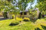 Charming single-story home with a welcoming covered entryway and a well-maintained front yard.