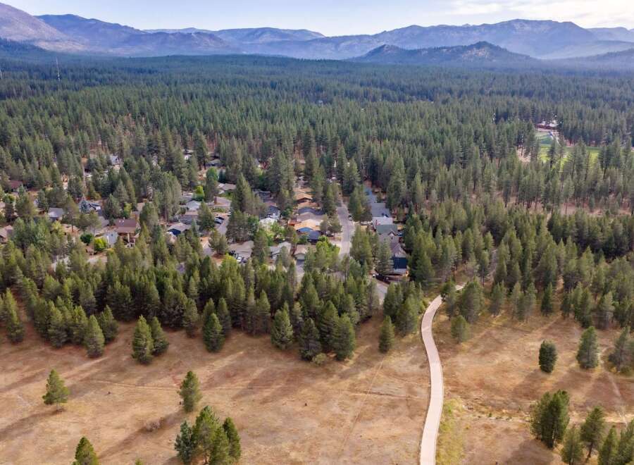 Discover your dream home nestled within a serene pine forest, offering a perfect blend of nature and community.