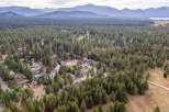 Discover this charming residential neighborhood nestled amidst a dense forest of tall pine trees.