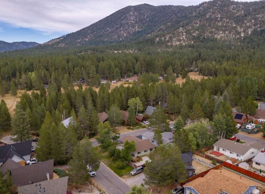 Nestled amidst a dense forest and towering mountains, this property offers a serene retreat.