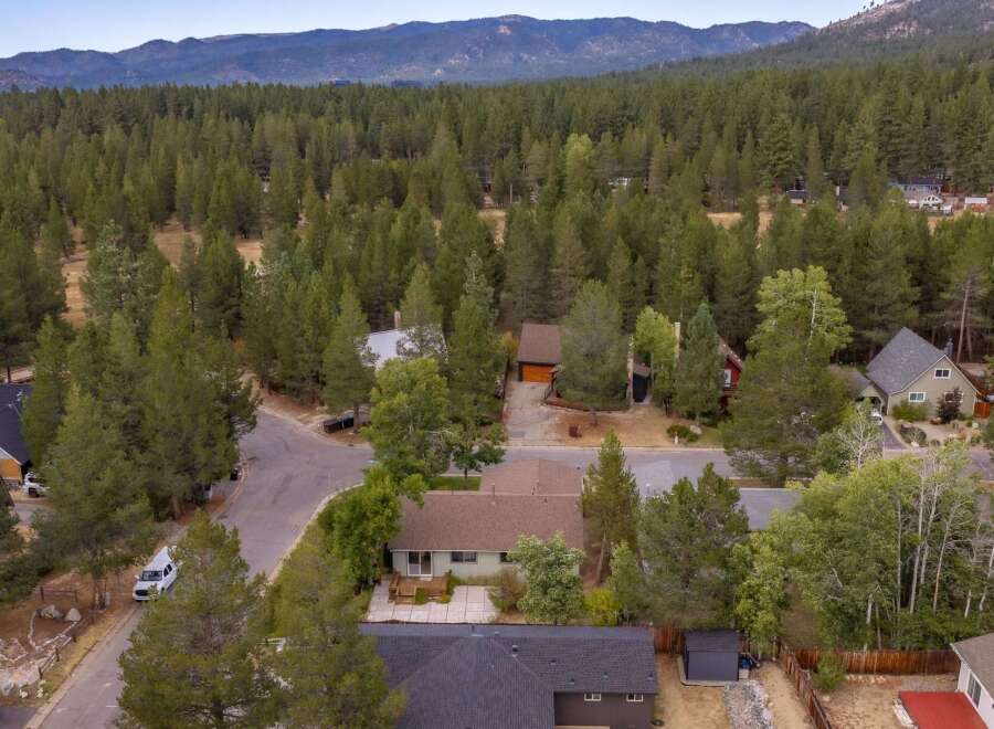 Discover this charming home nestled amidst a dense forest, offering a serene and private retreat.