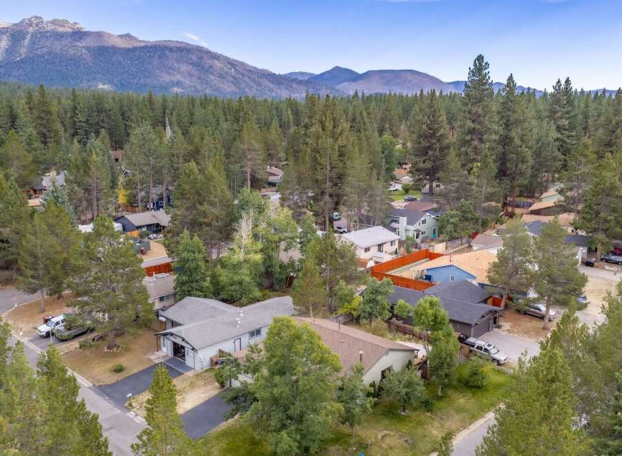 Discover this charming neighborhood nestled amongst towering pine trees, offering a serene mountain escape.