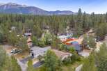 Discover this charming neighborhood nestled amongst towering pine trees, offering a serene mountain escape.