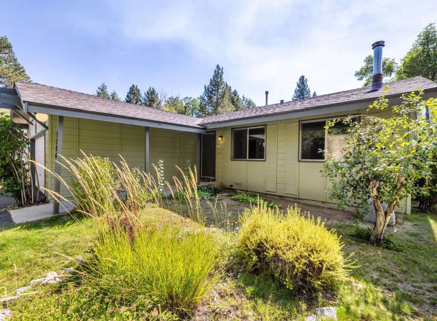 Discover this charming single-story home nestled amongst mature trees, offering a serene and private setting.