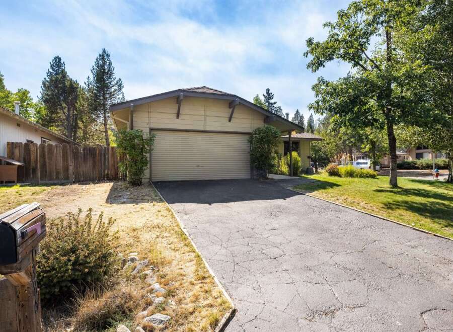 This charming single-family home features a spacious two-car garage, perfect for vehicles and storage.