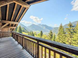 Experience breathtaking mountain views from this charming wooden balcony, perfect for enjoying your morning coffee or evening wine.