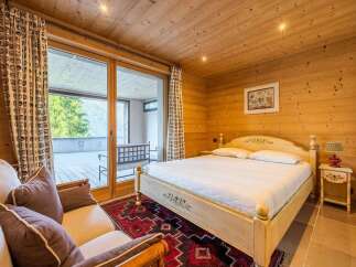 Experience rustic charm and mountain views in this cozy bedroom.