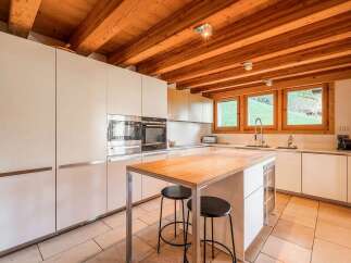 Experience modern living in this stunning kitchen featuring sleek white cabinetry and integrated stainless steel appliances.