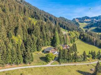 Nestled amidst a lush alpine forest, this charming property offers a serene mountain retreat.