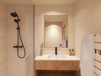 Experience modern comfort in this beautifully appointed bathroom, featuring a sleek walk-in shower with a rainfall showerhead and elegant tiled walls.
