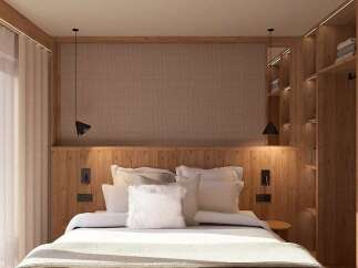Experience modern comfort in this beautifully designed bedroom, featuring a plush king-sized bed with crisp white linens and an abundance of decorative pillows.