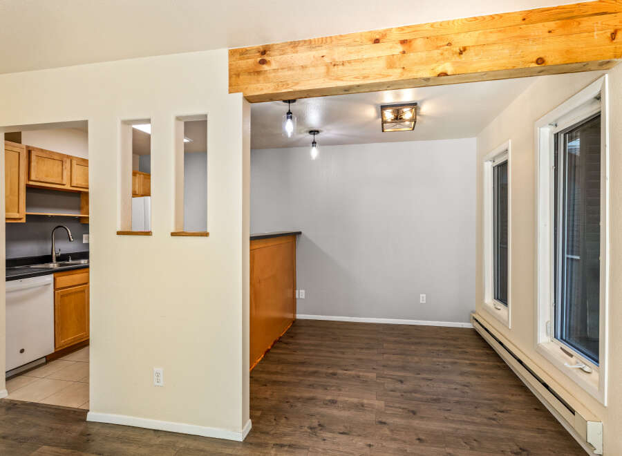 Discover this charming home featuring a modern kitchen with ample cabinet space and a sleek countertop.
