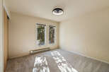 This empty room features a modern ceiling fan with light, perfect for year-round comfort.