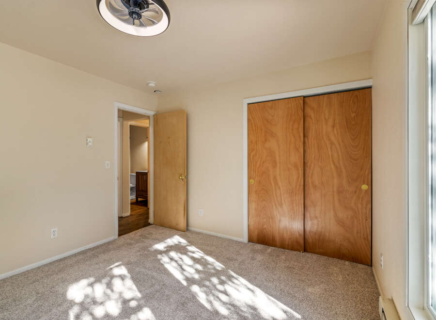 This bedroom features a light beige carpet and walls, creating a warm and inviting atmosphere.