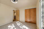 This bedroom features a light beige carpet and walls, creating a warm and inviting atmosphere.