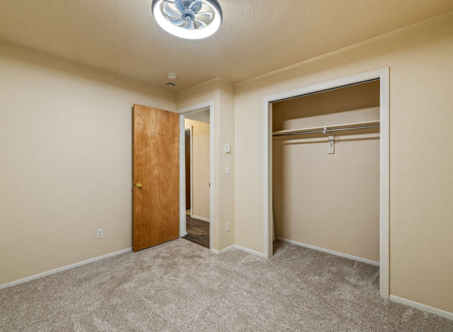 Step into this inviting bedroom featuring plush, neutral carpeting that complements the warm, neutral walls.