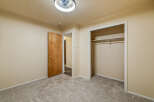 Step into this inviting bedroom featuring plush, neutral carpeting that complements the warm, neutral walls.