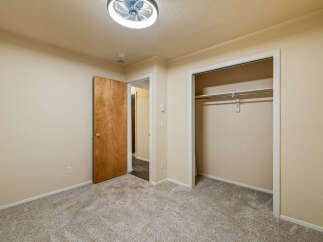 Step into this inviting bedroom featuring plush, neutral carpeting that complements the warm, neutral walls.