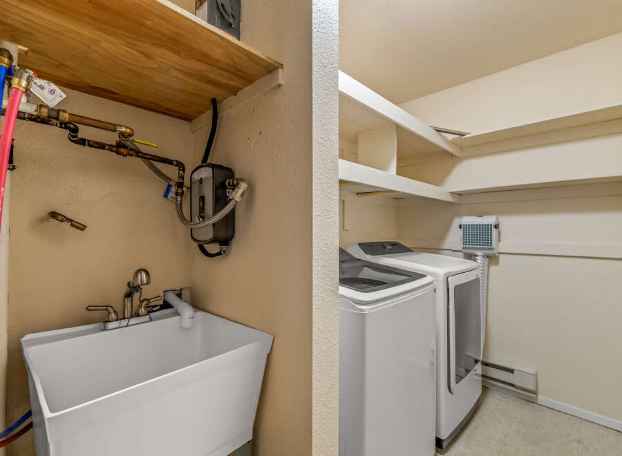 This laundry room offers a practical and functional space for your household needs.