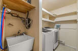 This laundry room offers a practical and functional space for your household needs.
