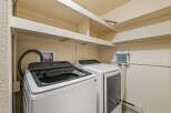 This laundry room features a Samsung top-load washer and a matching dryer, perfect for handling your family's laundry needs.