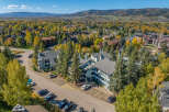 Experience the beauty of autumn in this aerial view of a residential community nestled amongst vibrant fall foliage.