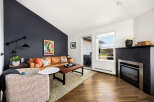 Step into this inviting living room featuring a warm leather sofa and a stylish accent chair, perfect for relaxation.
