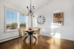 Bright and airy dining area featuring a round wooden table with four modern chairs, perfect for family meals.