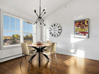 Bright and airy dining area featuring a round wooden table with four modern chairs, perfect for family meals.