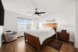 Experience comfort and style in this inviting bedroom, featuring a spacious wooden bed with crisp white linens.