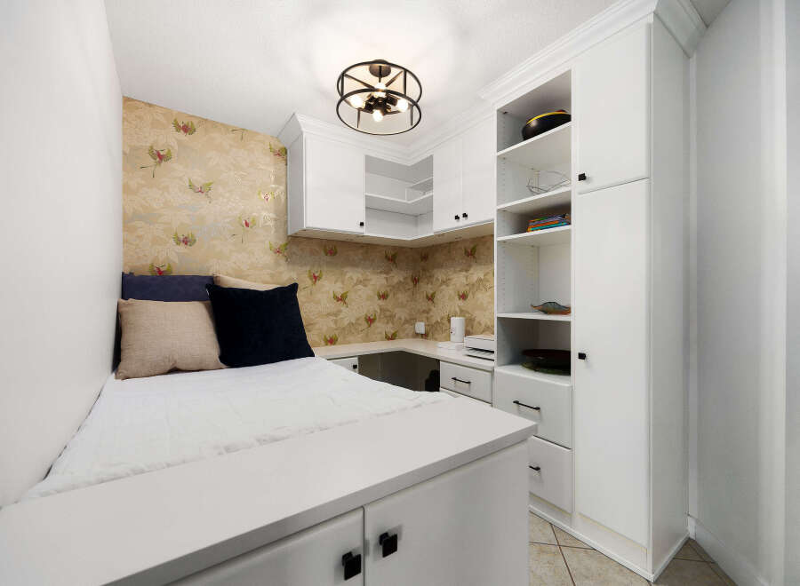 This compact living space features a built-in bed with ample storage underneath, perfect for maximizing a small area.