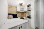 This compact living space features a built-in bed with ample storage underneath, perfect for maximizing a small area.