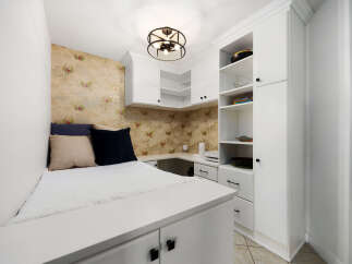 This compact living space features a built-in bed with ample storage underneath, perfect for maximizing a small area.