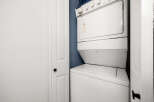 This laundry room features a stacked white washer and dryer unit, perfect for maximizing space in smaller homes or apartments.