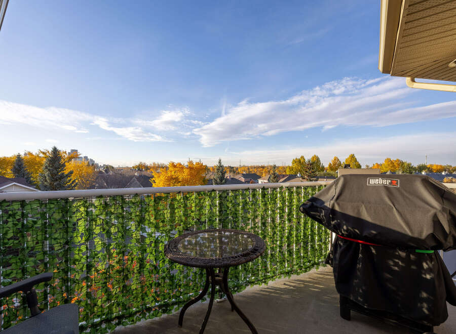 Enjoy outdoor living on this charming balcony, complete with a Weber grill perfect for summer cookouts.
