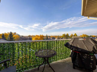 Enjoy outdoor living on this charming balcony, complete with a Weber grill perfect for summer cookouts.