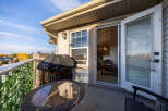 Enjoy outdoor living on this spacious balcony, complete with a covered grill and a charming bistro set perfect for morning coffee or evening relaxation.