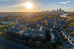 Experience the vibrant autumn colors surrounding this modern apartment complex, offering a serene living environment.