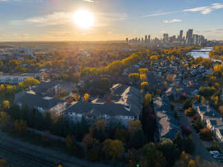 Experience the vibrant autumn colors surrounding this modern apartment complex, offering a serene living environment.