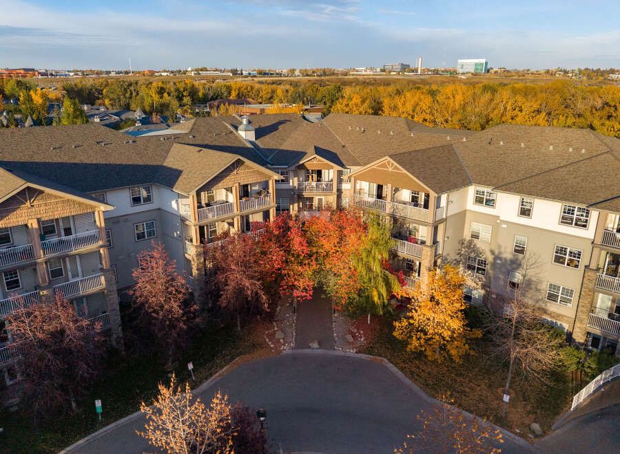 Experience luxury living in this stunning apartment complex, bathed in the warm glow of autumn.