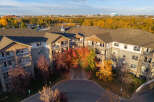 Experience luxury living in this stunning apartment complex, bathed in the warm glow of autumn.