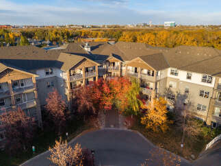 Experience luxury living in this stunning apartment complex, bathed in the warm glow of autumn.