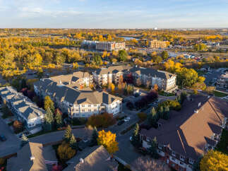 Experience modern living in this stunning apartment complex, nestled amidst vibrant autumn foliage.