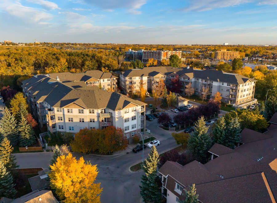Experience modern living in this stunning apartment complex, bathed in the warm glow of autumn.