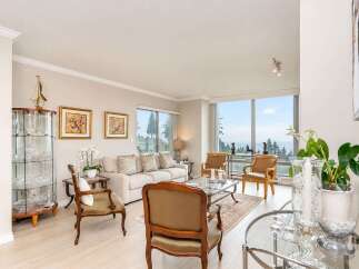 Experience breathtaking ocean and forest views from this stunning living room.