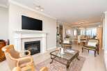 Experience elegant living in this spacious open-concept home, featuring a modern fireplace and a large flat-screen TV.